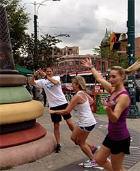 Running Rats passing the thimble sculpture commemorating Toronto's old Garment District