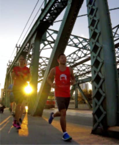 Running east over the Broadview bridge at sunset