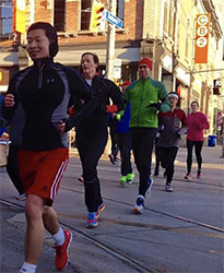 A group of Running Rats heading north on Bathurst Street